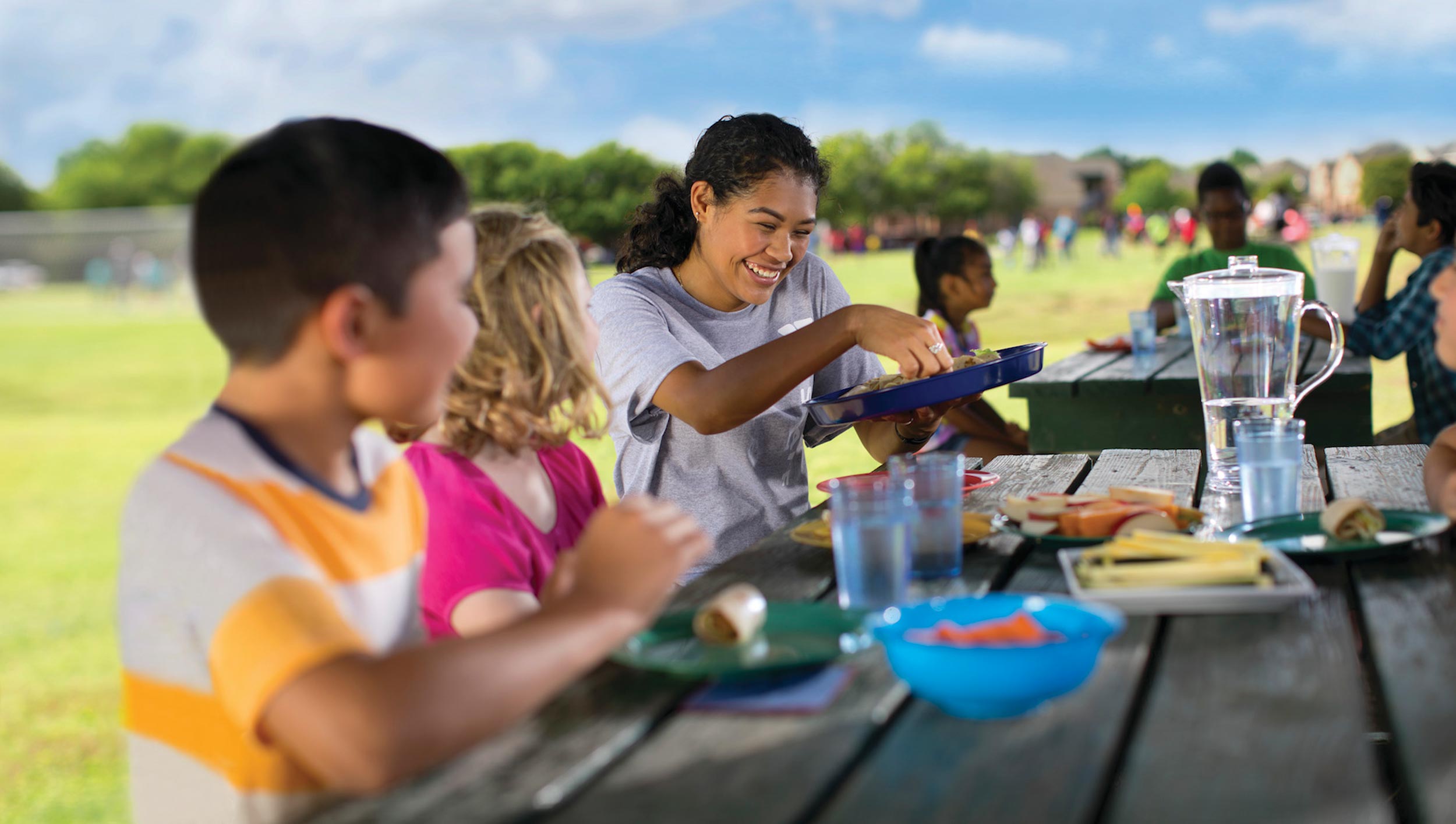 Healthy Eating Children share a picnic lunch with a counselor
