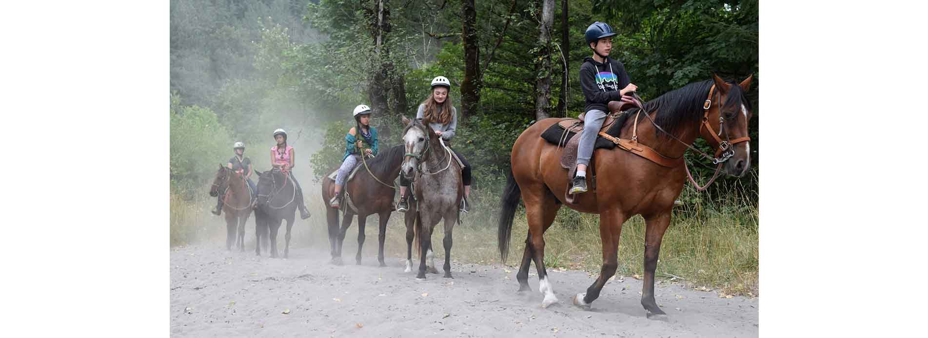 YMCA Camps Children ride horses on trail