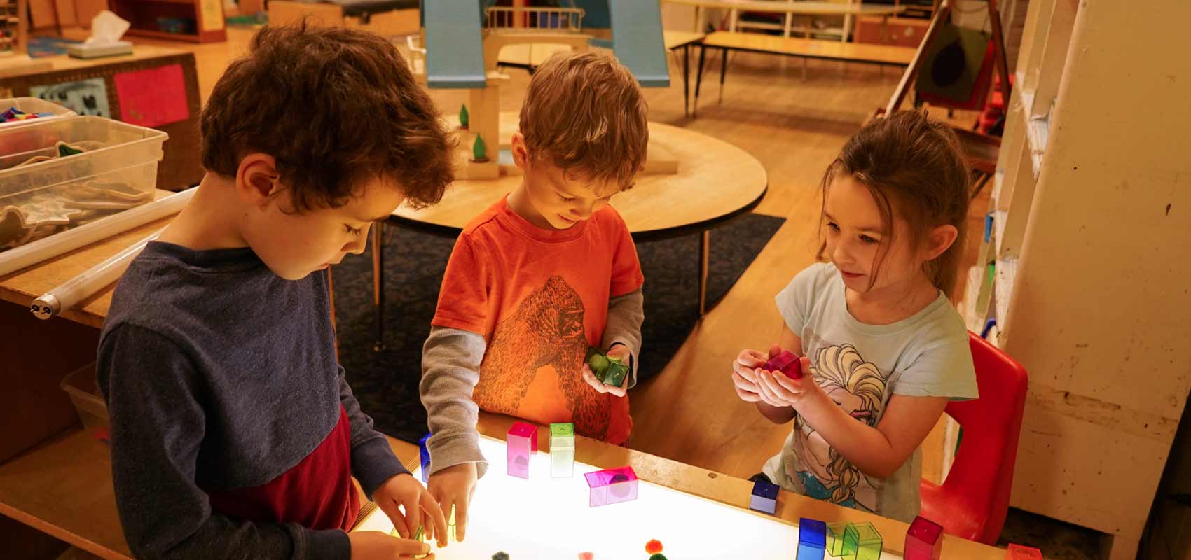 YMCA Youth Children play with building blocks in classroom