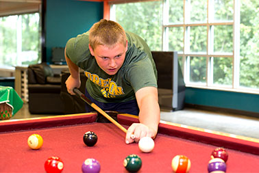 YMCA Youth & Teen Center Young boy shoots pool, billiards