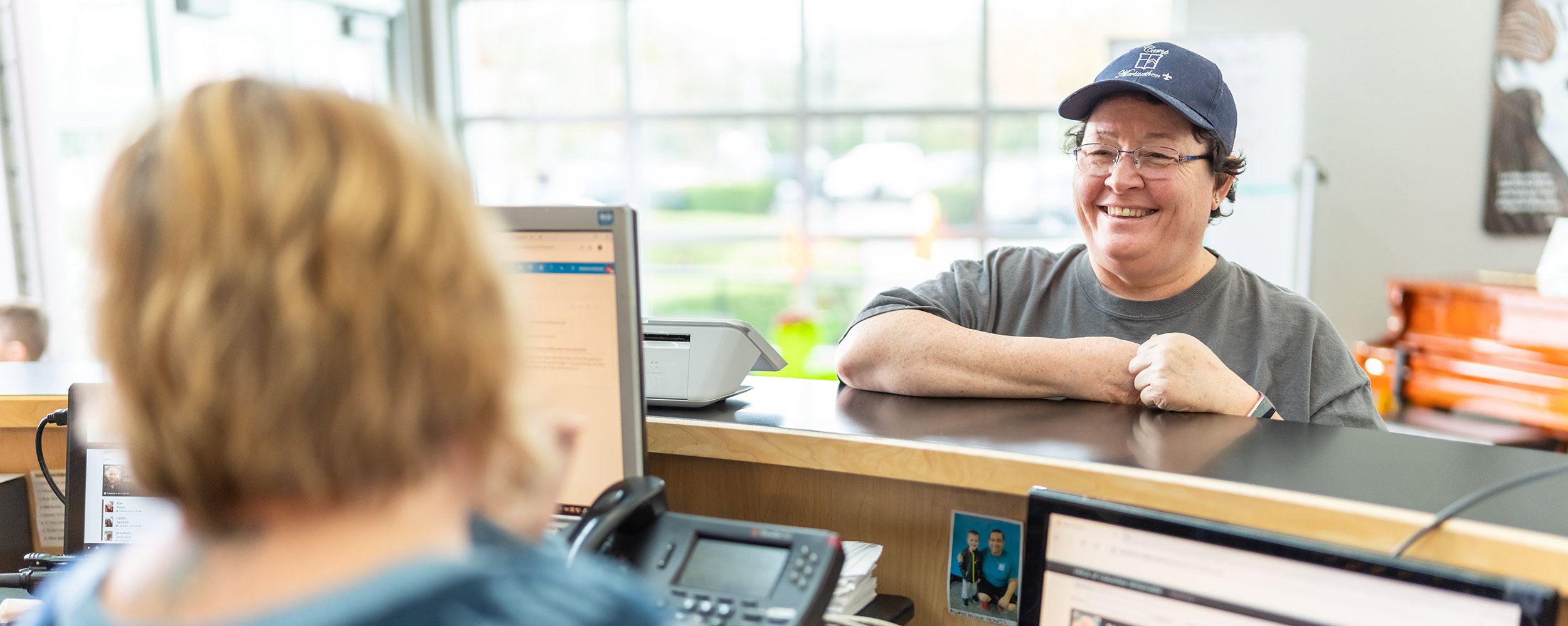 Person smiling with Y Staff at Membership Desk